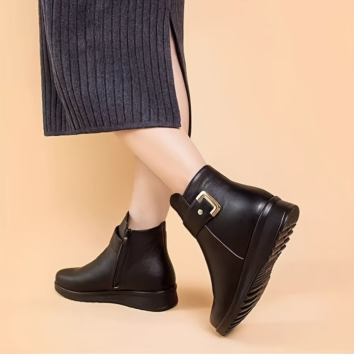 Guinevere buckle ankle boots worn on model, side profile