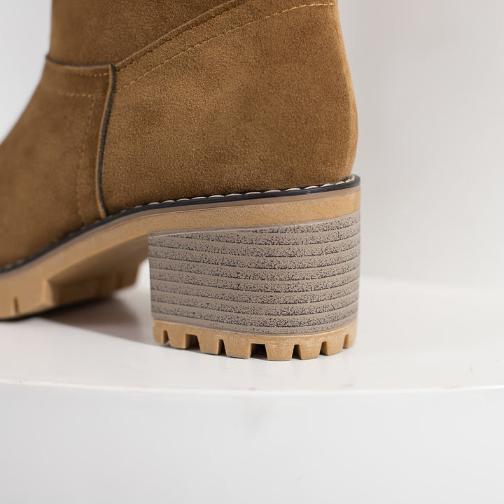 Thea cuffed block heel boots held in hand, close-up detail
