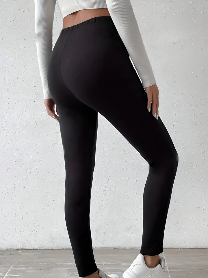 Thalassa fleece lined slim leggings, back view in black