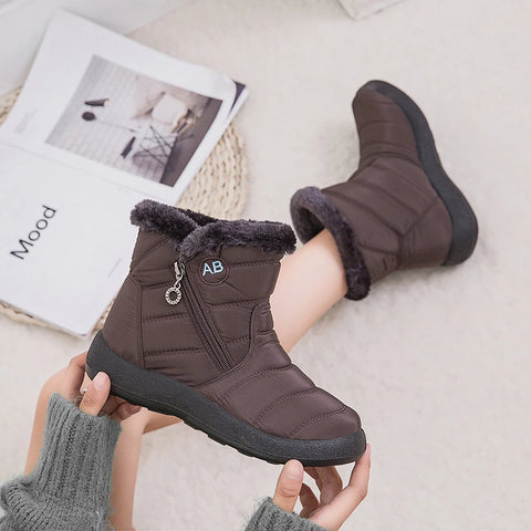 Wilhelmina brown fur trim zip winter boot held in hand with newspaper backdrop