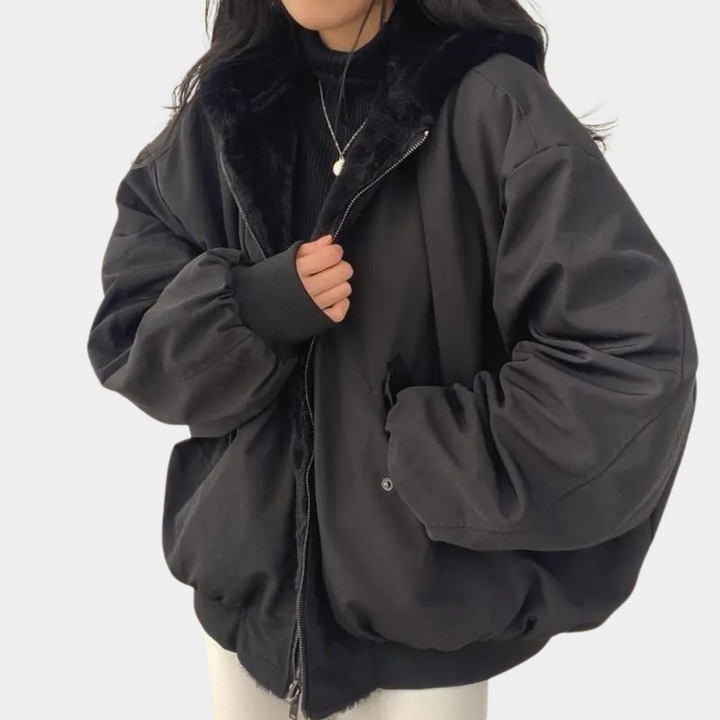 Céleste hooded oversized puffer jacket in black, front view with hood up