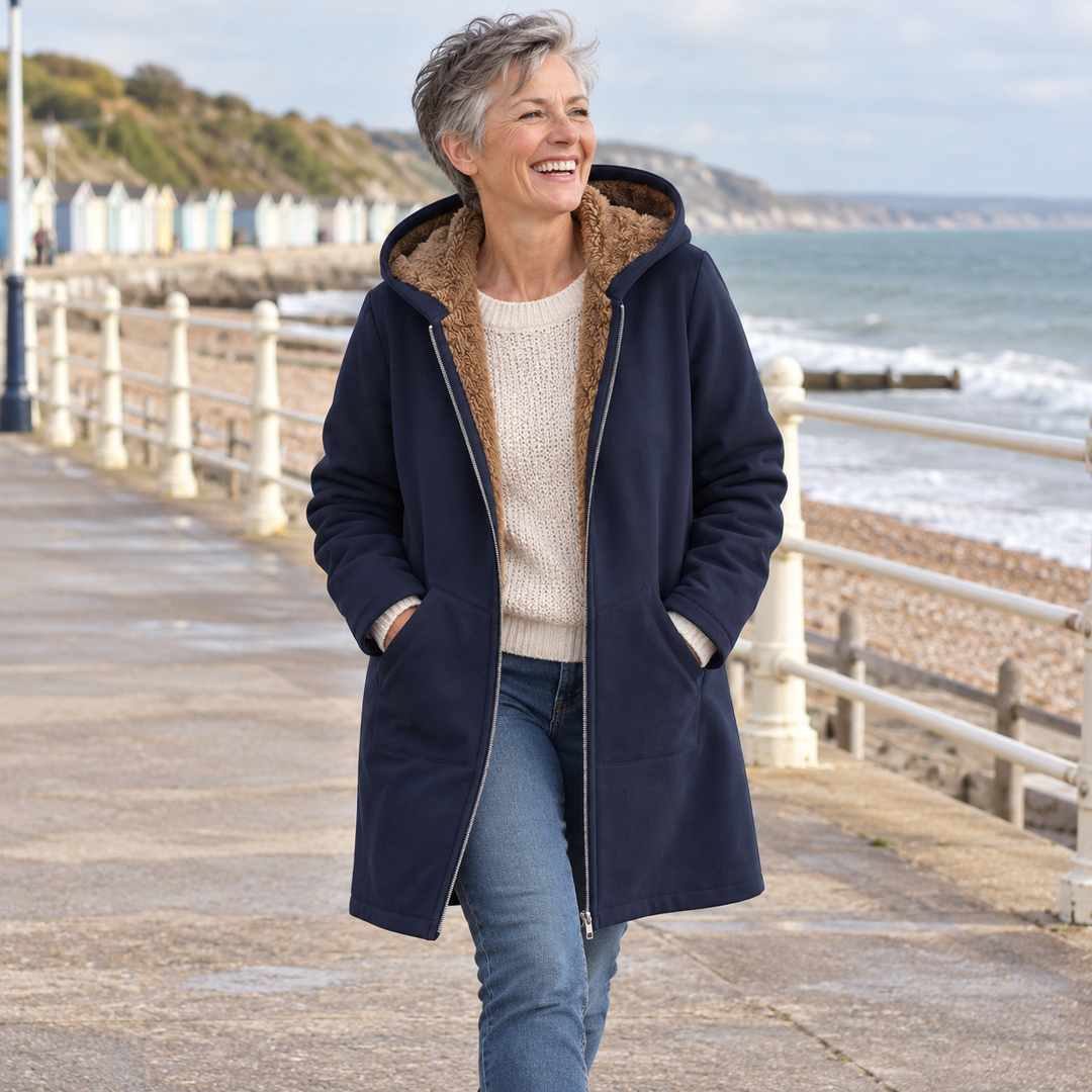 Woman wearing Rosalind navy hooded coat outdoors on a boardwalk