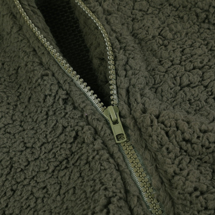 Pauline sherpa jacket zipper pull close-up in green