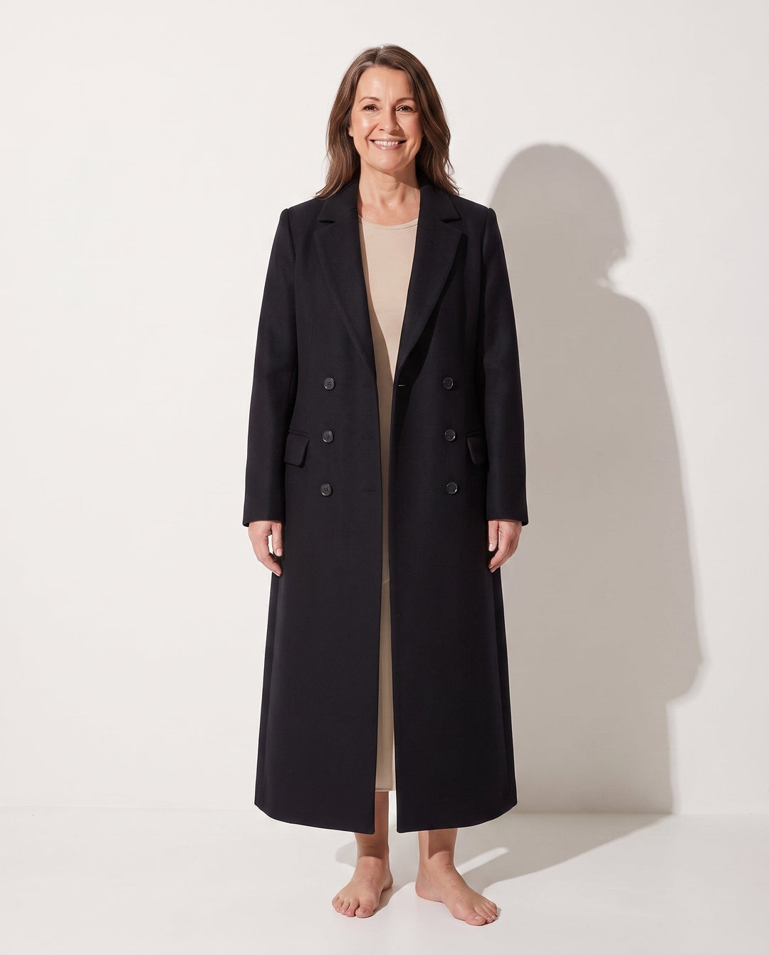 Delphine longline double-breasted coat in black, front view on model