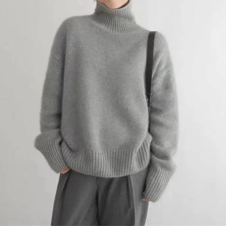 Rosalind turtleneck sweater in cream, side view with tote bag