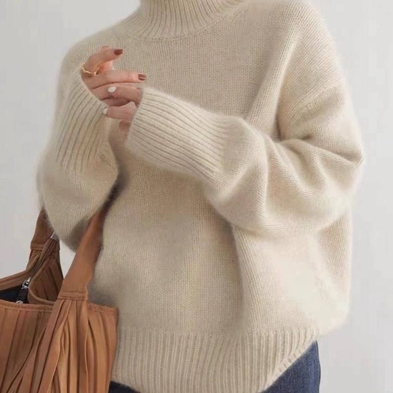 Rosalind turtleneck sweater in cream, side view with tote bag