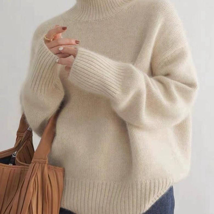 Rosalind turtleneck sweater in cream, side view with tote bag