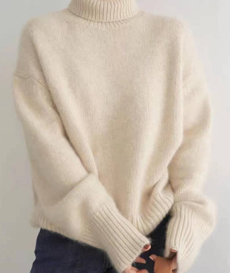 Rosalind turtleneck sweater in cream, side view with tote bag