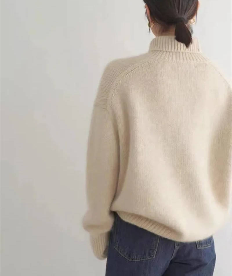 Rosalind turtleneck sweater in cream, side view with tote bag