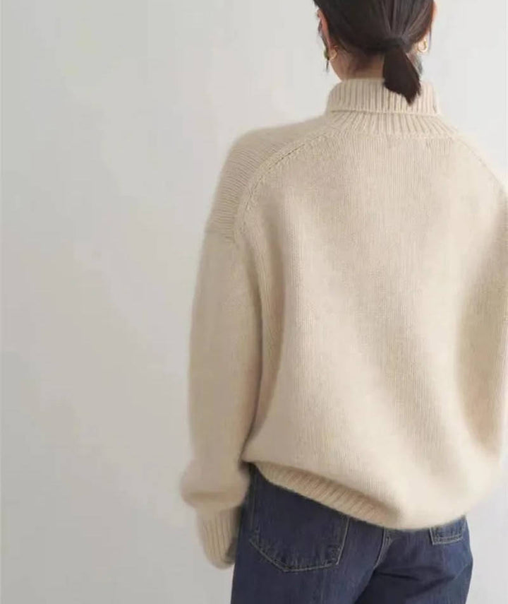 Rosalind turtleneck sweater in cream, side view with tote bag