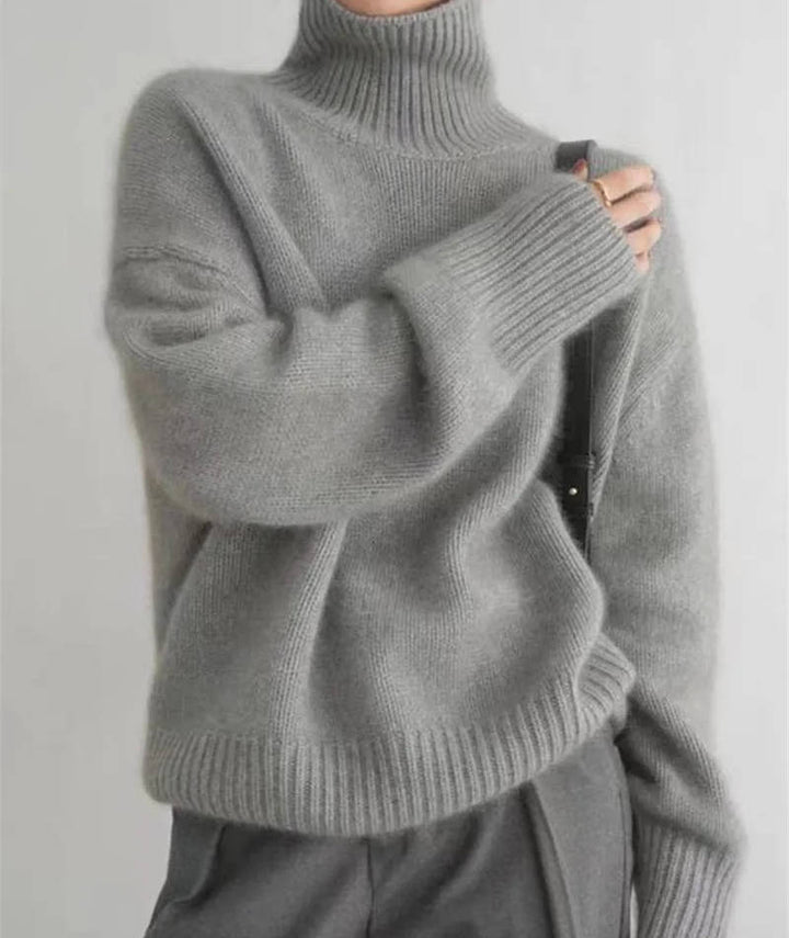 Rosalind turtleneck sweater in cream, side view with tote bag