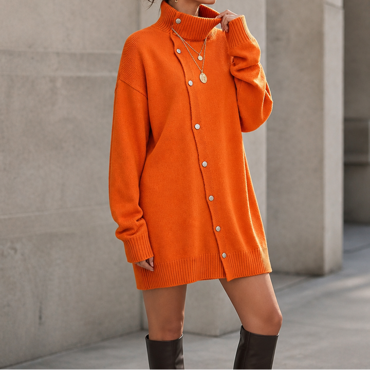 Marigold oversized turtleneck sweater dress, seated side view with ankle boots