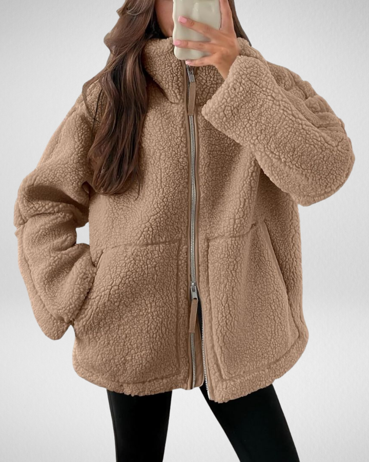 Odalys oversized sherpa jacket in taupe, front view with hands in pockets