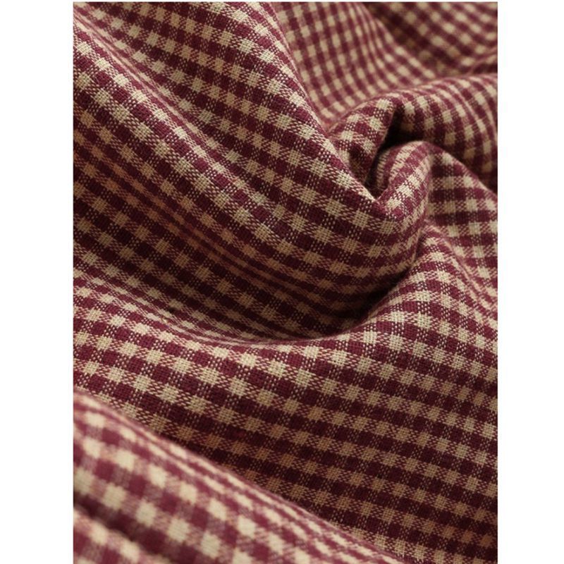 Close-up of Esmeralda coat plaid pattern fabric texture