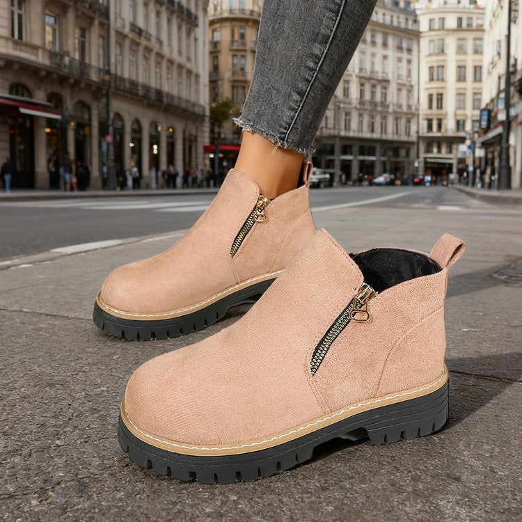 Pink platform ankle boots with side zip on model, street background