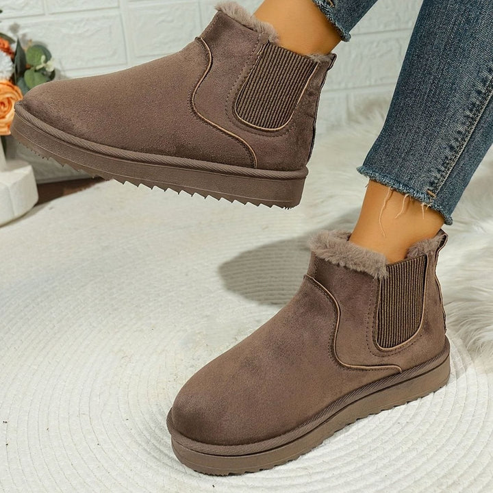 Thea plush-lined slip-on ankle boots in taupe, side view with foot lifted