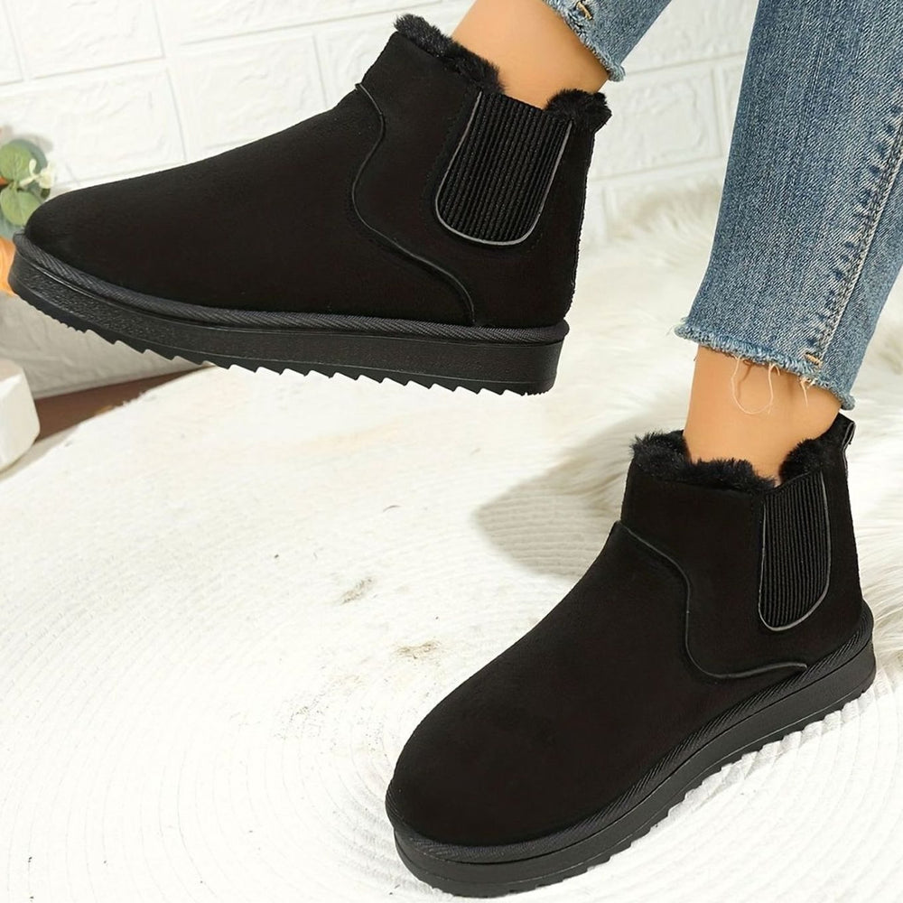 Thea plush-lined slip-on ankle boots in black, front view on model