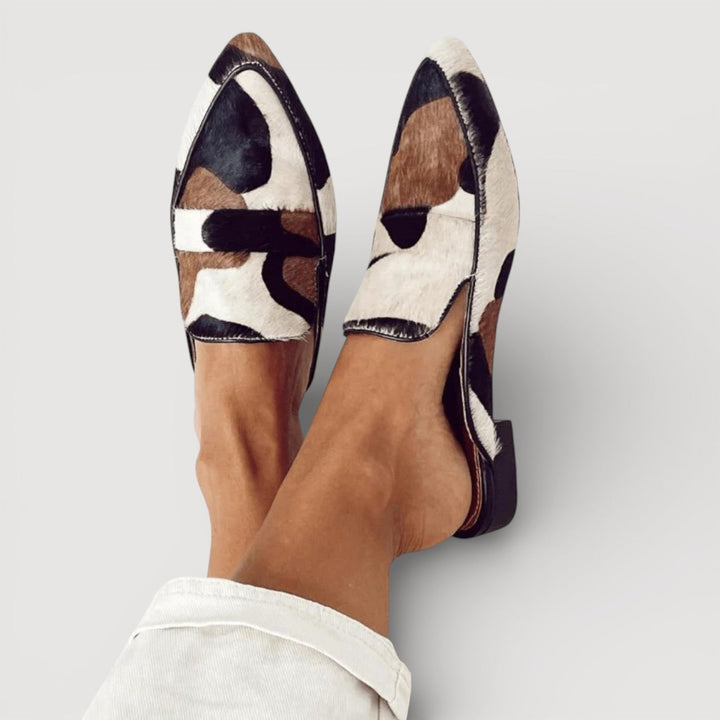Marisela pointed toe printed loafers worn on crossed feet, front view