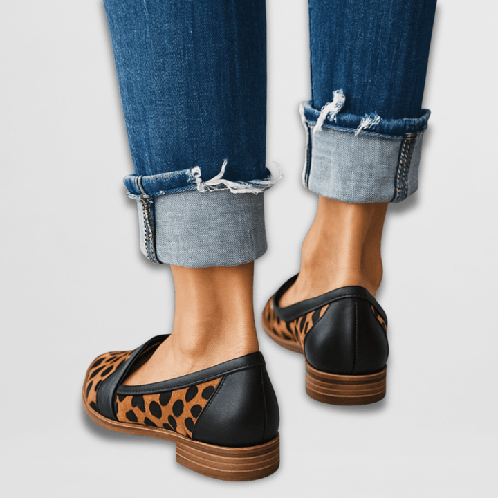 Rosalind leopard print pointed toe slip-on loafers worn with cuffed jeans, front view