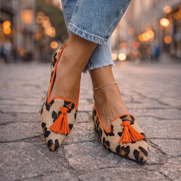 Marisol leopard print pointed toe loafers with orange tassel, worn with denim, street style view