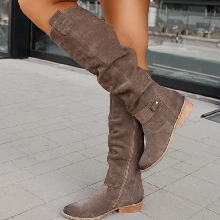 Georgette slouch knee high boots in taupe, side view on model walking