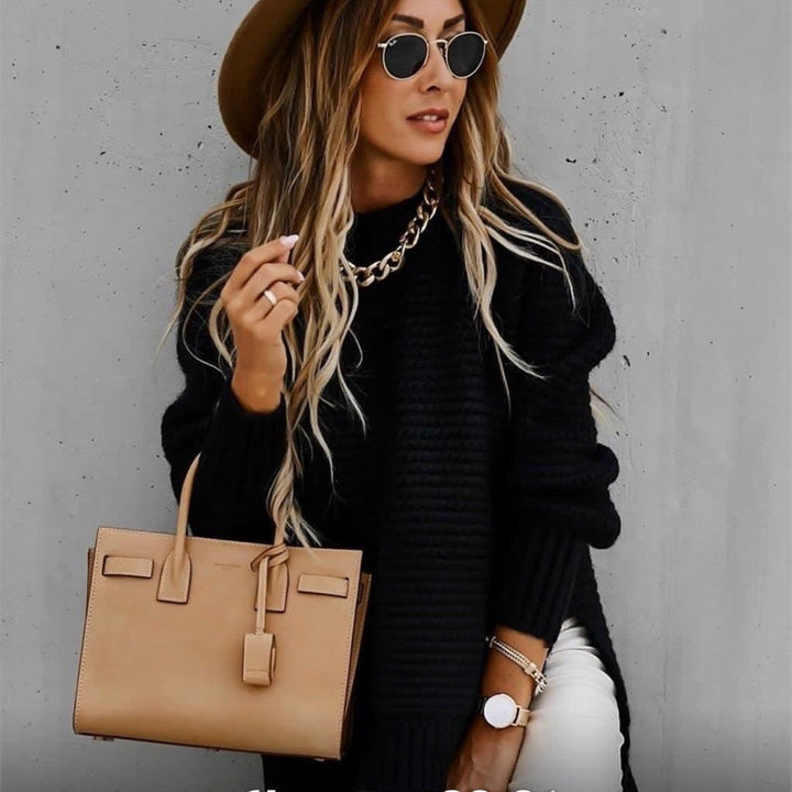 Delphine oversized turtleneck sweater in black, styled with hat and handbag