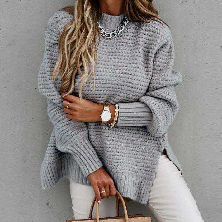 Delphine oversized turtleneck sweater in beige, front view with handbag