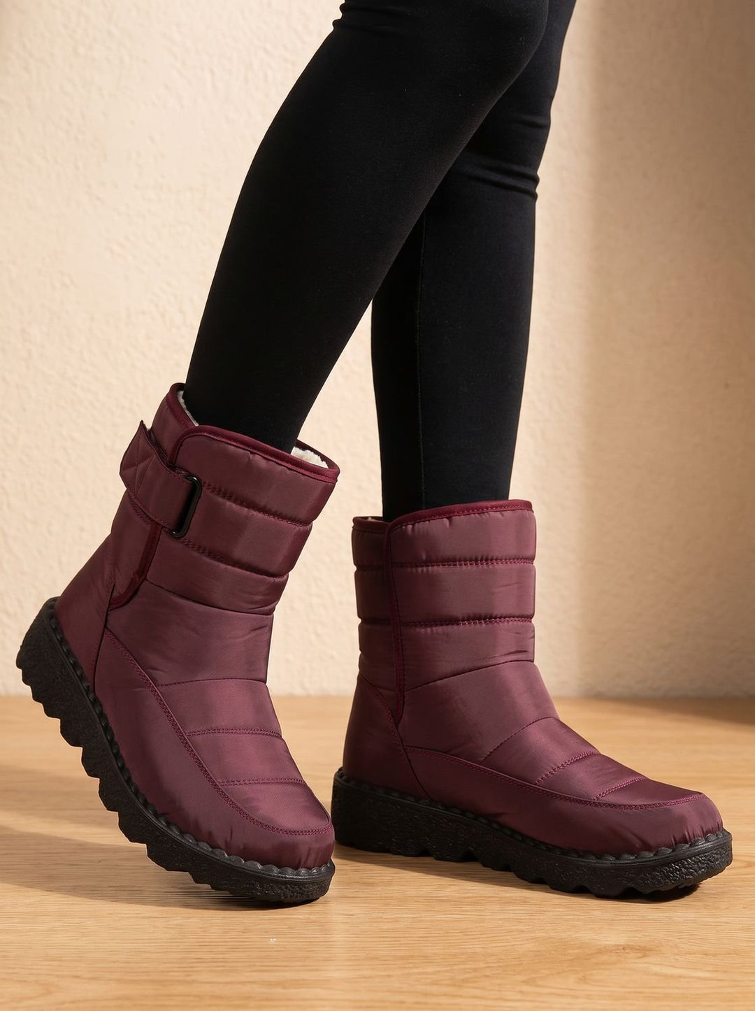Marigold waterproof mid-calf snow boots worn on model, side view