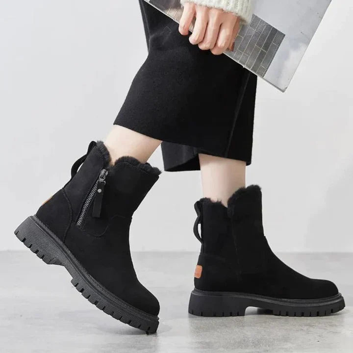 Winnifred black ankle boots worn with cropped pants, walking view