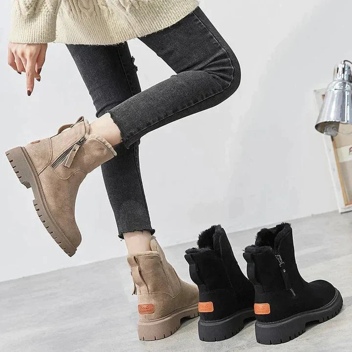 Winnifred black ankle boots worn with cropped pants, walking view