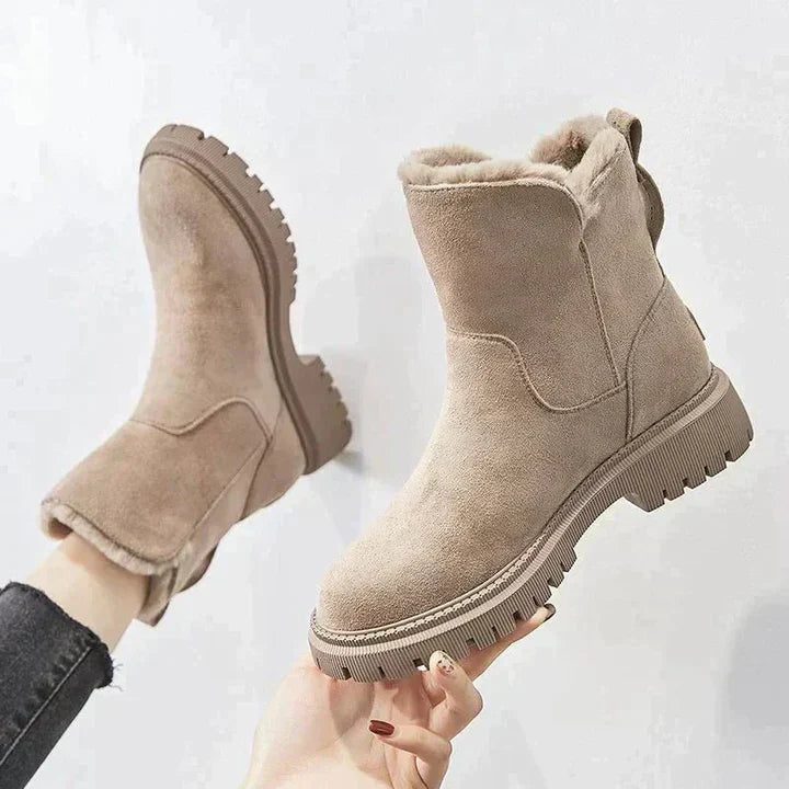 Winnifred black ankle boots worn with cropped pants, walking view