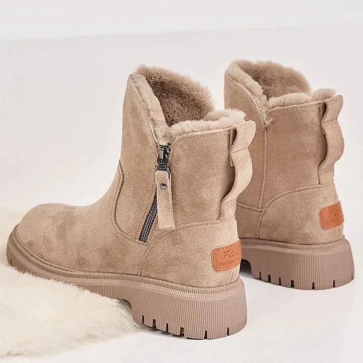 Winnifred black ankle boots worn with cropped pants, walking view