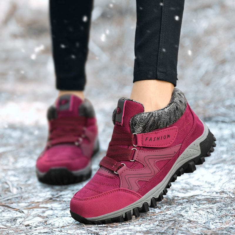 Wren fur trim winter ankle boots in burgundy, worn outdoors in snow
