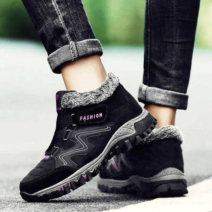 Wren fur trim ankle boots in black with pink accents, side view