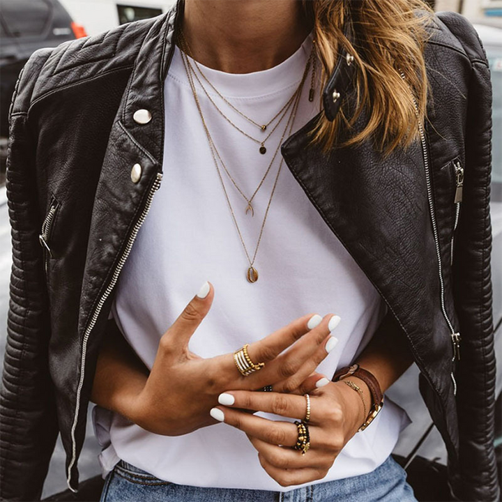 Wren cropped biker jacket layered over a white tee, front view with layered necklaces