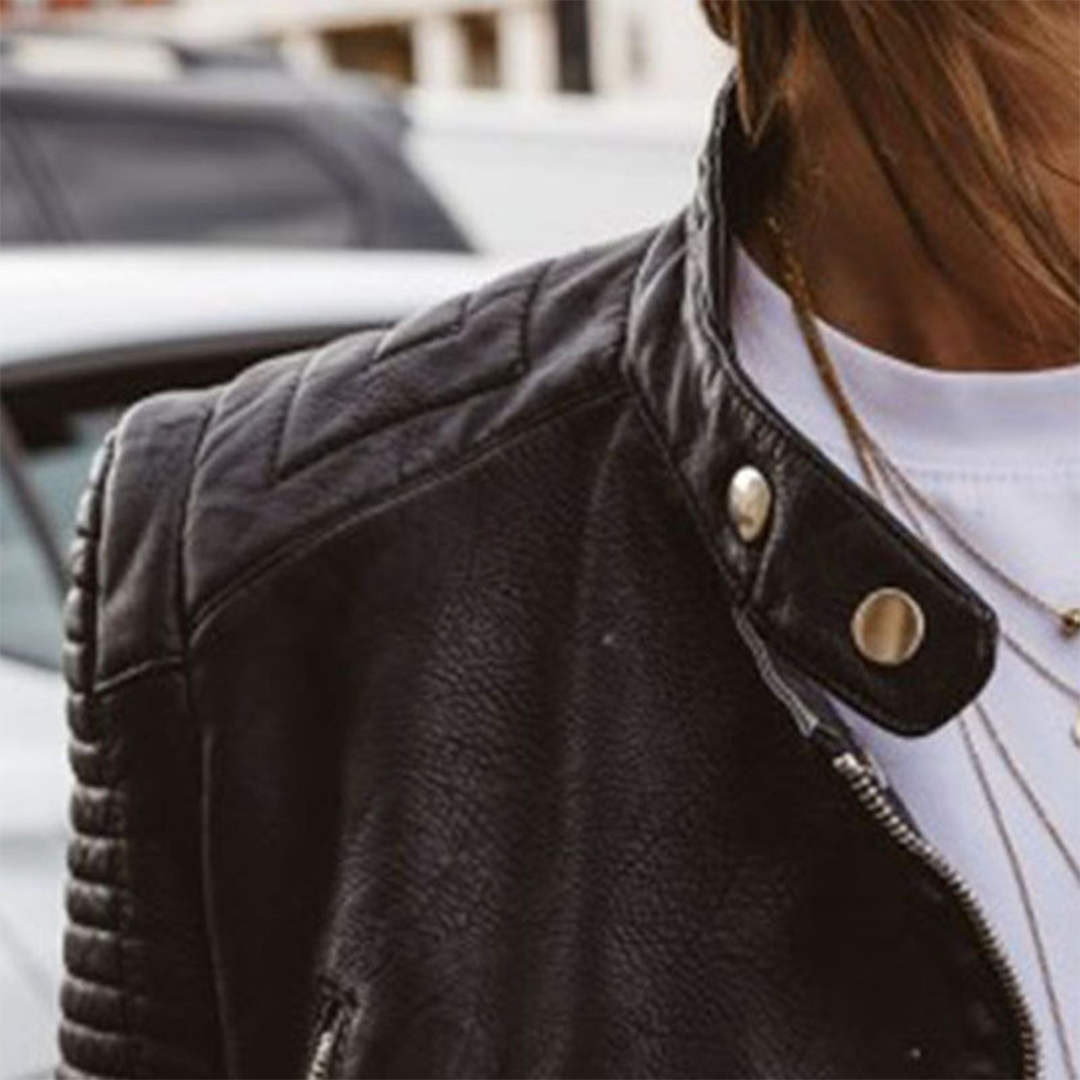 Close-up of Wren biker jacket quilted shoulder and snap-tab collar detail
