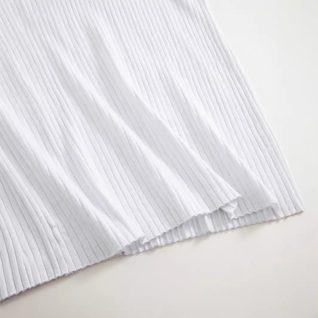 Close-up of white ribbed knit fabric texture on Wren dress hem