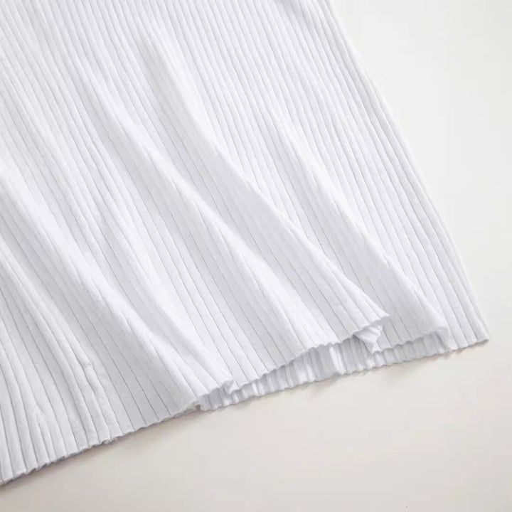 Close-up of white ribbed knit fabric texture on Wren dress hem