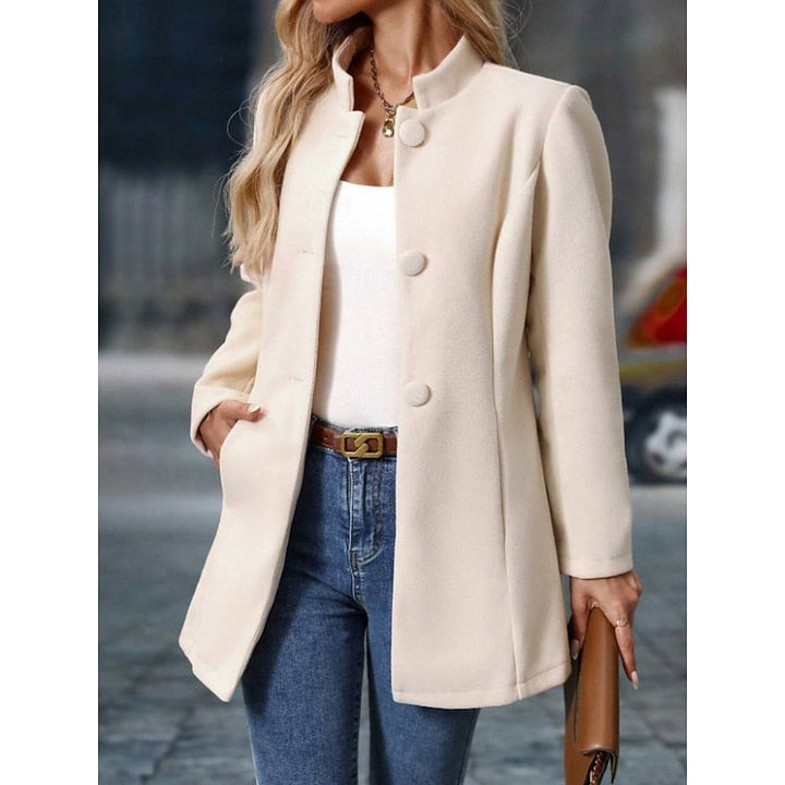 Wren stand collar coat with hand in pocket, front detail