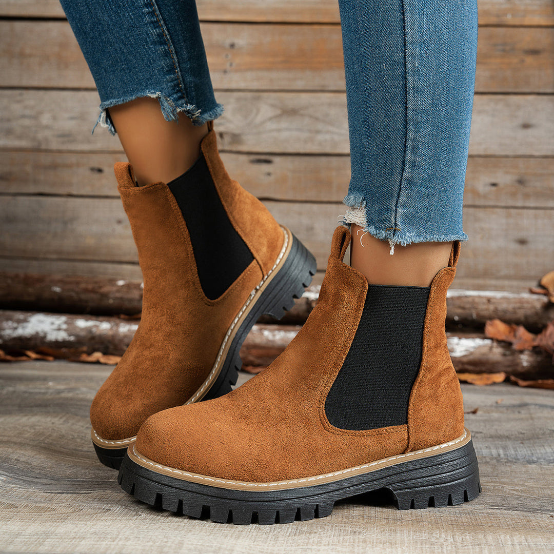 Wynter Chelsea boots in brown, side view on model