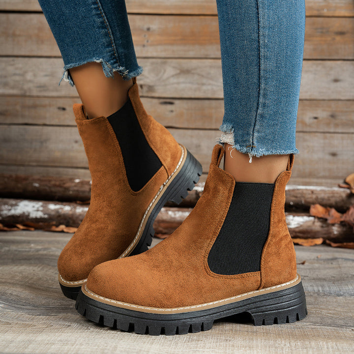 Wynter Chelsea boots in brown, side view on model