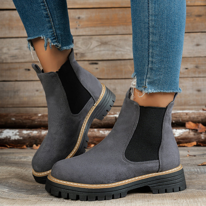 Wynter Chelsea boots in gray, side view on model