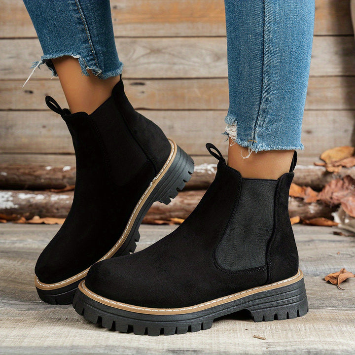 Wynter Chelsea boots in black, side view on model