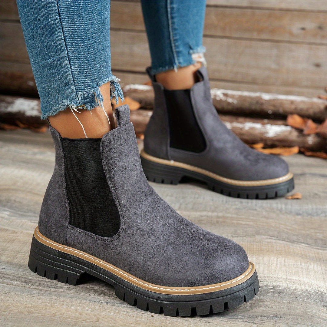Wynter Chelsea boots in gray, side view close-up on model
